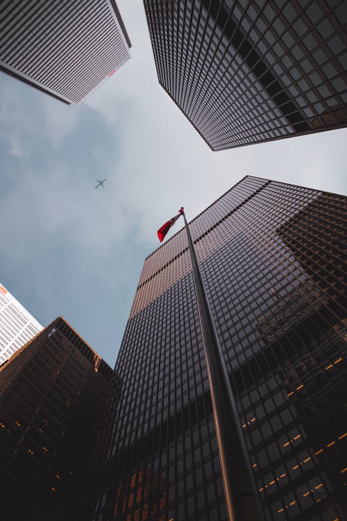 services-03 Low angle of modern skyscrapers with a Canadian flag in downtown Toronto.